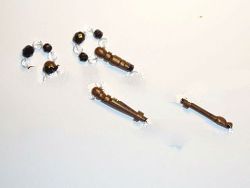 A pair of PARTRIDGE WOOD lace bobbins with STONE inlay .