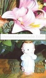 Little Angel of October under the artificial pink Lily flowers decoration