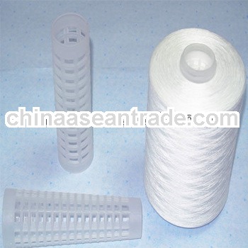 raw white bobbin cone of spun polyester sewing thread