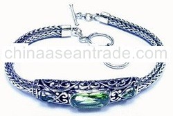 Silver Bracelet With Three Peridot And Carving