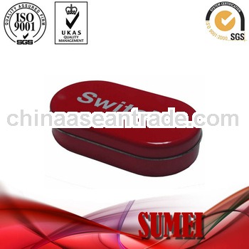 Small red oval tin box