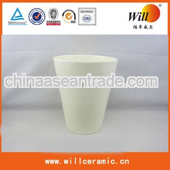 cup-shaped white ceramic flowerpot